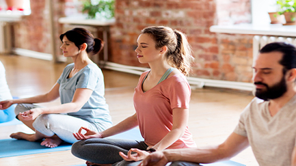 Four people take part in meditation.
