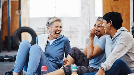 Older ladies sitting laughing in the gym