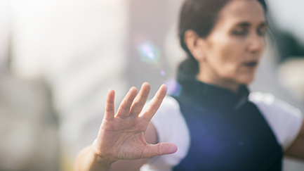 Person with their arms out practicing tai chi
