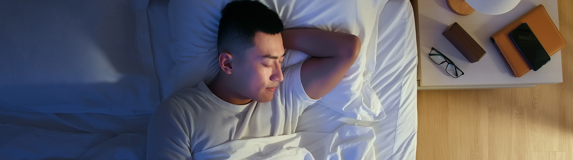 A man sleeping in a bed.