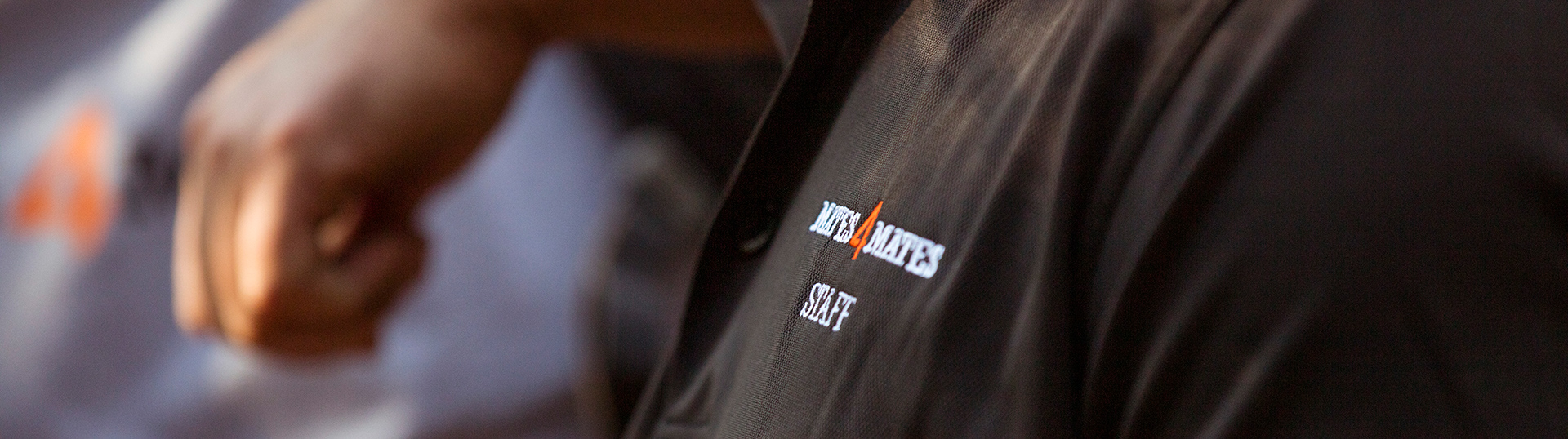 Mates4Mates logo on a black shirt.